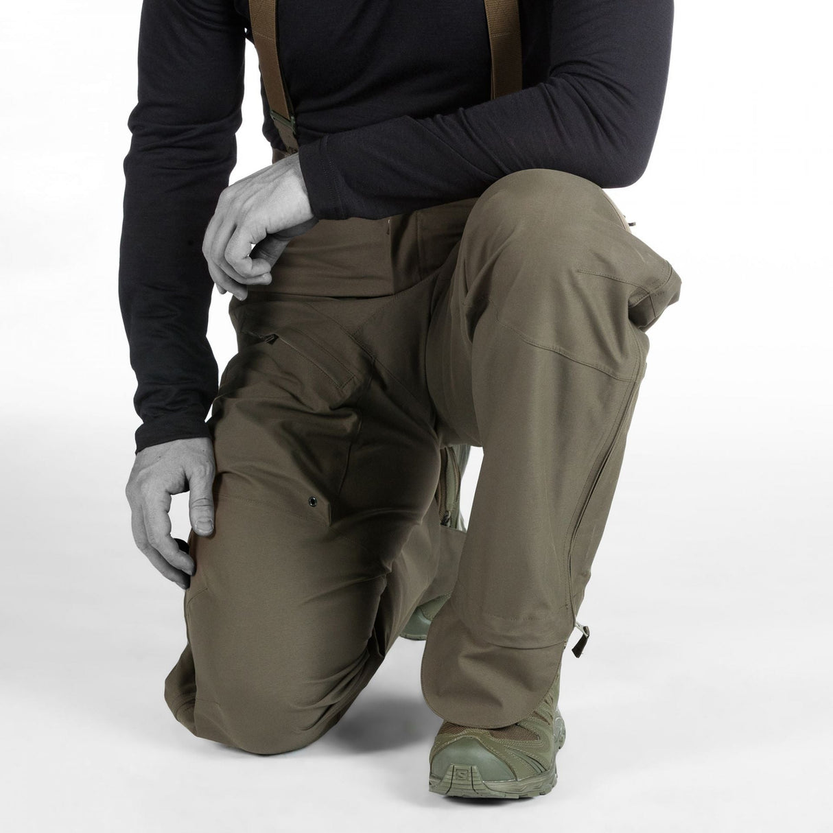 Tactical Waterproof Trousers: Black pants with extended back for enhanced coverage.
